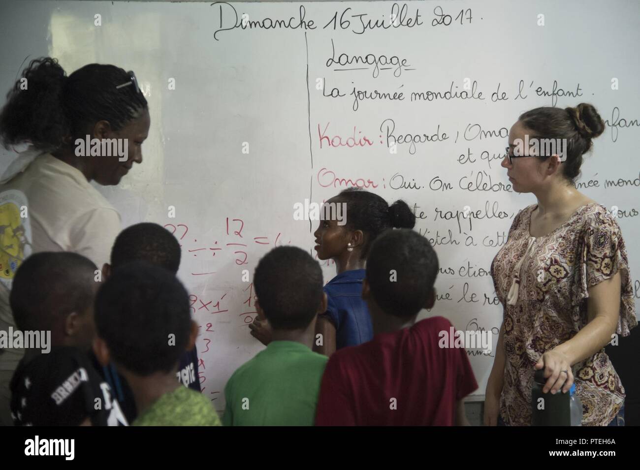 U.S. service members from Combined Joint Task Force-Horn of Africa and Camp Lemonnier, Djibouti, volunteer to teach at Association De Developpment Et Protection De L’Enfant A Besoin (ADPEB), a charity organization in Djibouti City, July 16, 2017. The volunteers also raised donations to purchase eight gravity lights in an effort to provide an alternative energy source for lighting their classrooms. Stock Photo