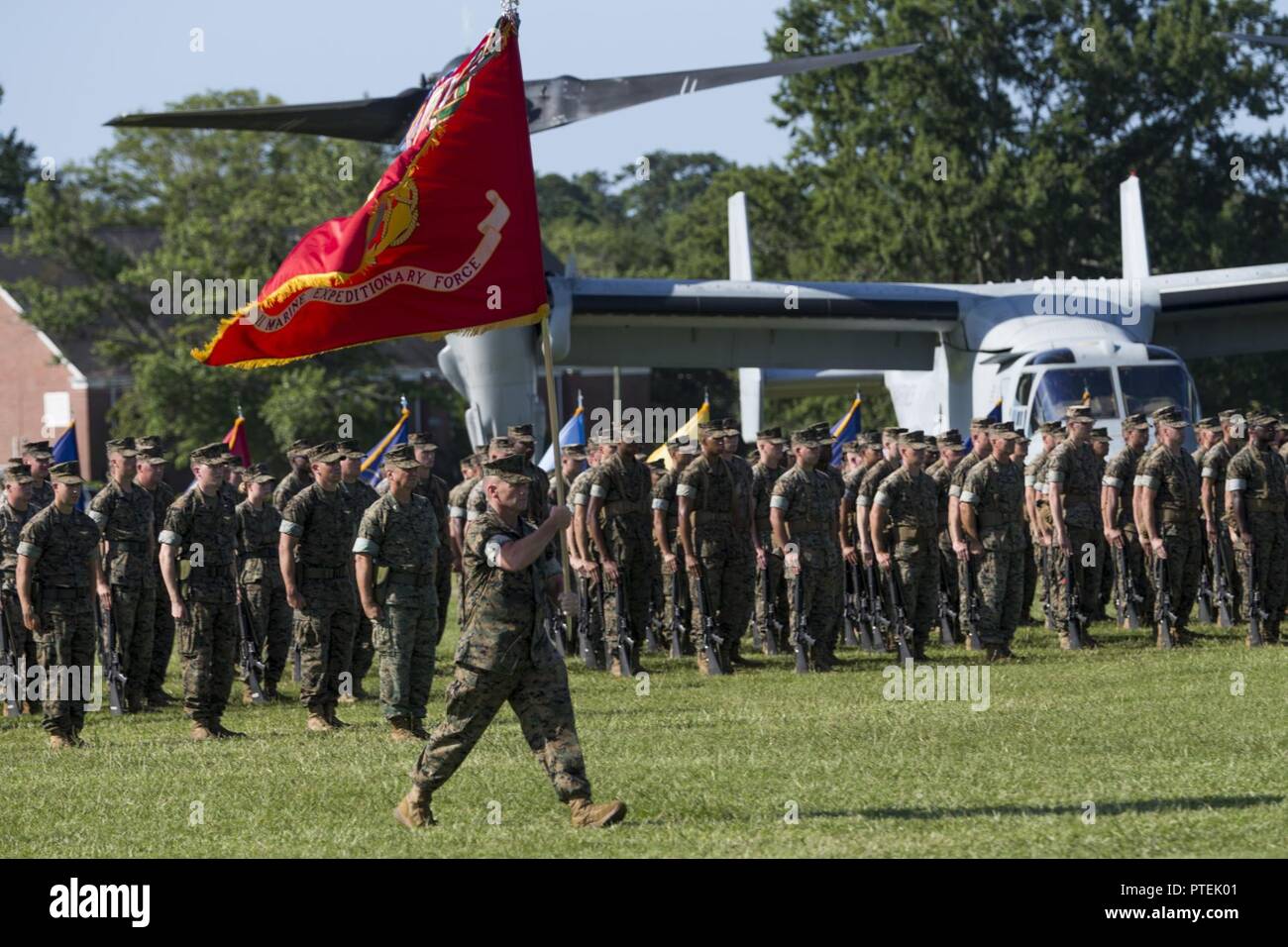 U.S. Marine Corps Sgt. Maj. Bryan Thresher, the II Marine Expeditionary Force (MEF) sergeant major, carries the unit colors during a change of command ceremony on Camp Lejeune, N.C., July 14, 2017. During the ceremony, Maj. Gen. Walter L. Miller Jr. relinquished his command as commanding general of II MEF to Lt. Gen. Robert F. Hedelund. Stock Photo
