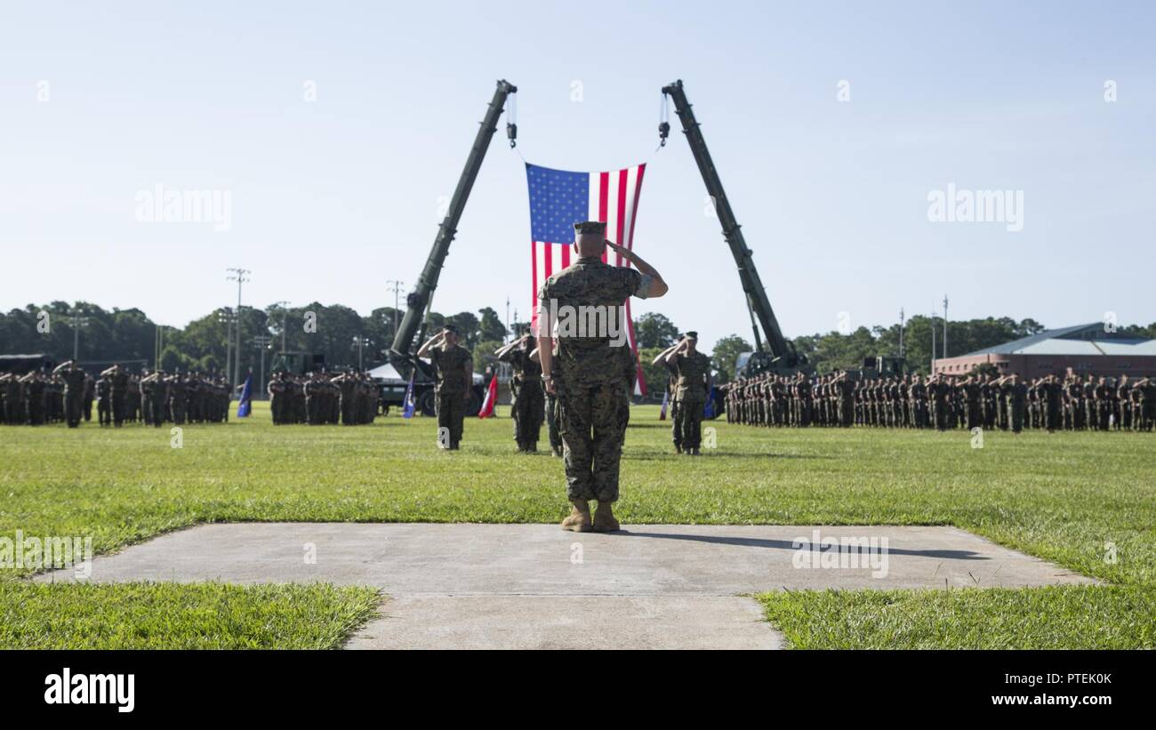 U.S. Marine Corps Lt. Gen. Robert F. Hedelund, center, commanding general of the II Marine Expeditionary Force (MEF) salutes Marines during a change of command ceremony on Camp Lejeune, N.C., July 14, 2017. During the ceremony, Maj. Gen. Walter L. Miller Jr. relinquished his command as commanding general of II MEF to Hedelund. Stock Photo