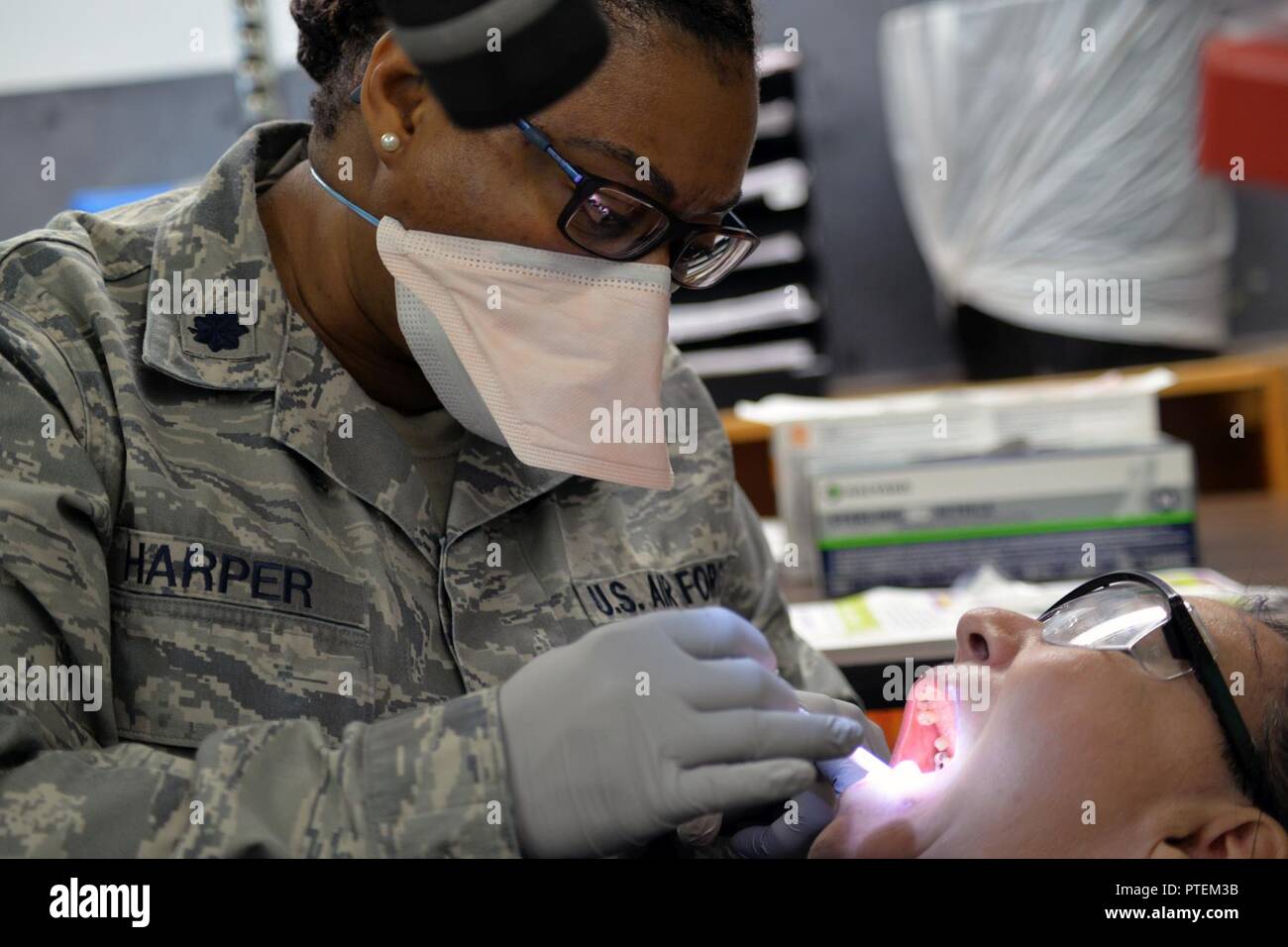 Lt. Colonel Tiffany Harper, dentist from 192th Medical Group cleans a patient teeth during a Innovative Readiness Training in Tangipahoa Parish, LA. July 14, 2017. Innovative Readiness Training builds mutually beneficial civil-military partnerships between US communities and the Department of Defense. These missions provide high quality, mission-essential training for Active, Guard, and Reserve support personnel and units. Stock Photo
