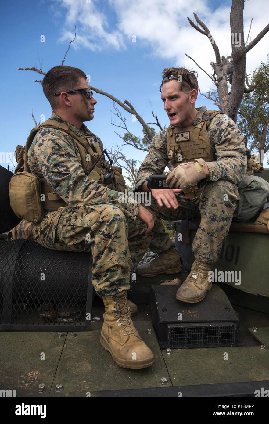 TOWNSHEND ISLAND, Australia (July 13, 2017) 1st Lt. James Heisler (left), from Pittsburgh, and Cpl. Ken Mullins, from Lapeer, Mich., both assigned to Battalion Landing Team, 3rd Battalion, 5th Marines, part of the 31st Marine Expeditionary Unit (MEU), discuss the terrain of a patrol route as part of a large-scale amphibious assault during Talisman Saber 17. The 31st MEU is working in tandem with Australian counterparts to train together in the framework of stability operations. Stock Photo