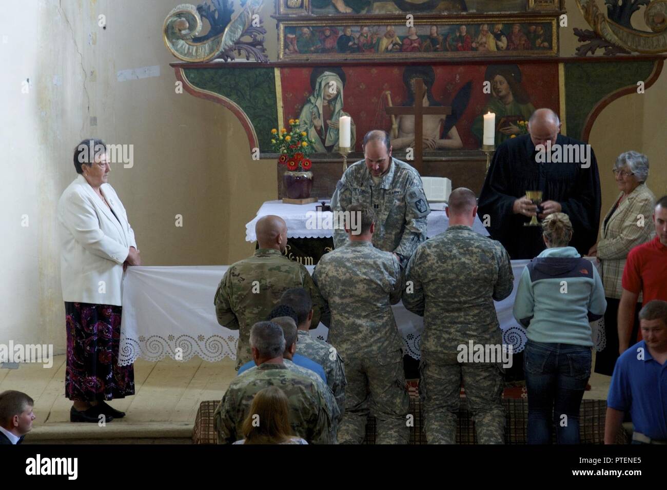 N.C. National Guard Chaplain Cpt. Rodney Dettmer works with Romanian Chaplain offering 5-113th Field Artillery Regiment Soldiers the opportunity to visit a local 800-year-old church and to commune with local parishioners during their Sunday mass in the town of Cincu, Romania on 17 July, 2017.  Soldiers were given a once in a lifetime opportunity to explore the historic church and to learn more about the history of the local town they have called home for Exercise Saber Guardian '17. Stock Photo