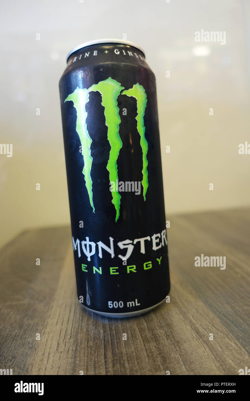 Monster Energy Drink on wooden table Stock Photo