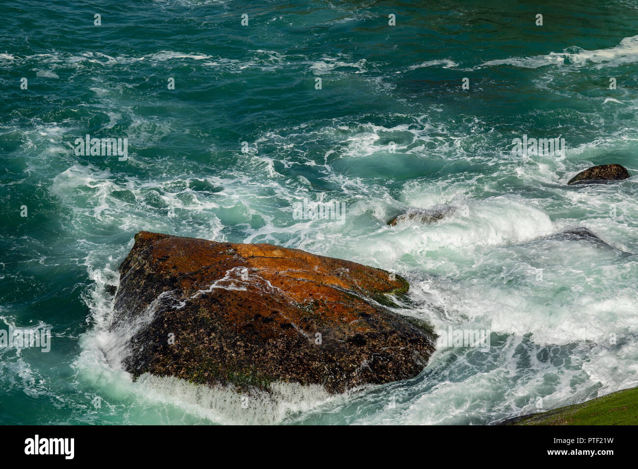 Sea waves breaking on a rocks in Brazil. Deep blue sea waves hit cliff ...