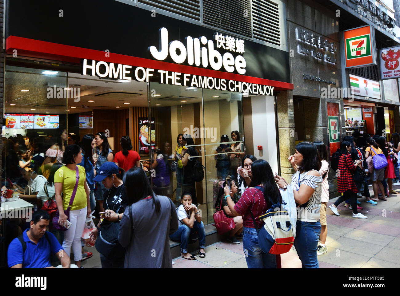 Filipino domestic helpers outside Jollibee fast food restaurant near