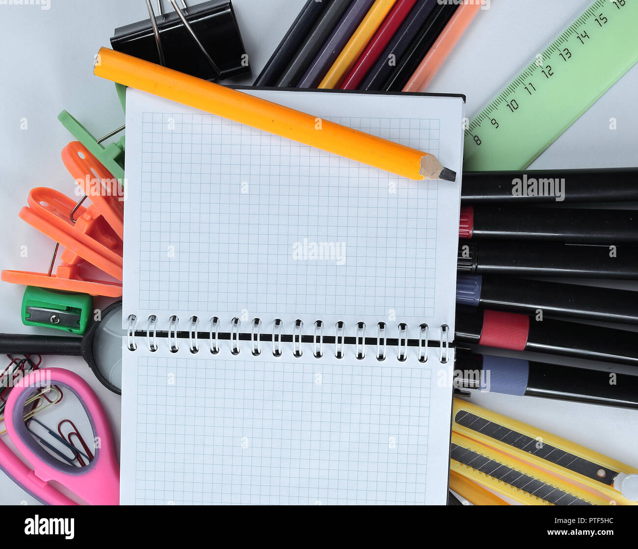 opened Notepad on office supplies on white background Stock Photo