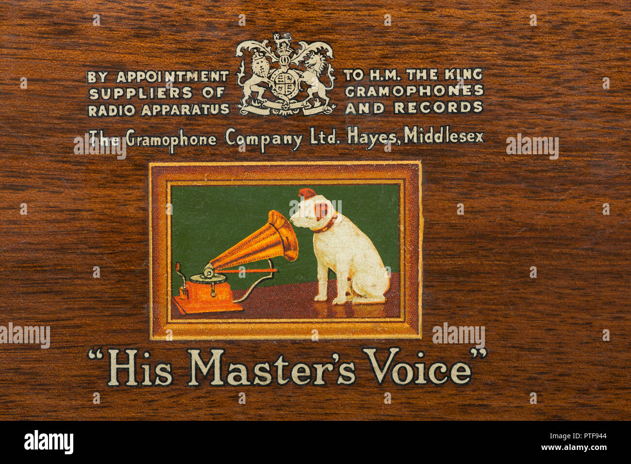Old HMV His masters voice logo with by appointment to HM His Majesty The King pre QEII reign, on old wooden radio gramophone Stock Photo