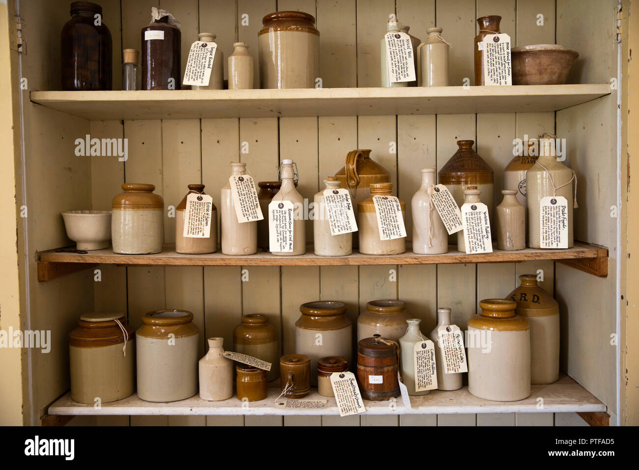 England, Berkshire,  Lower Basildon, Basildon Park Old Kitchen, labelled old stonewars jars, jugs and bottles on shelf Stock Photo