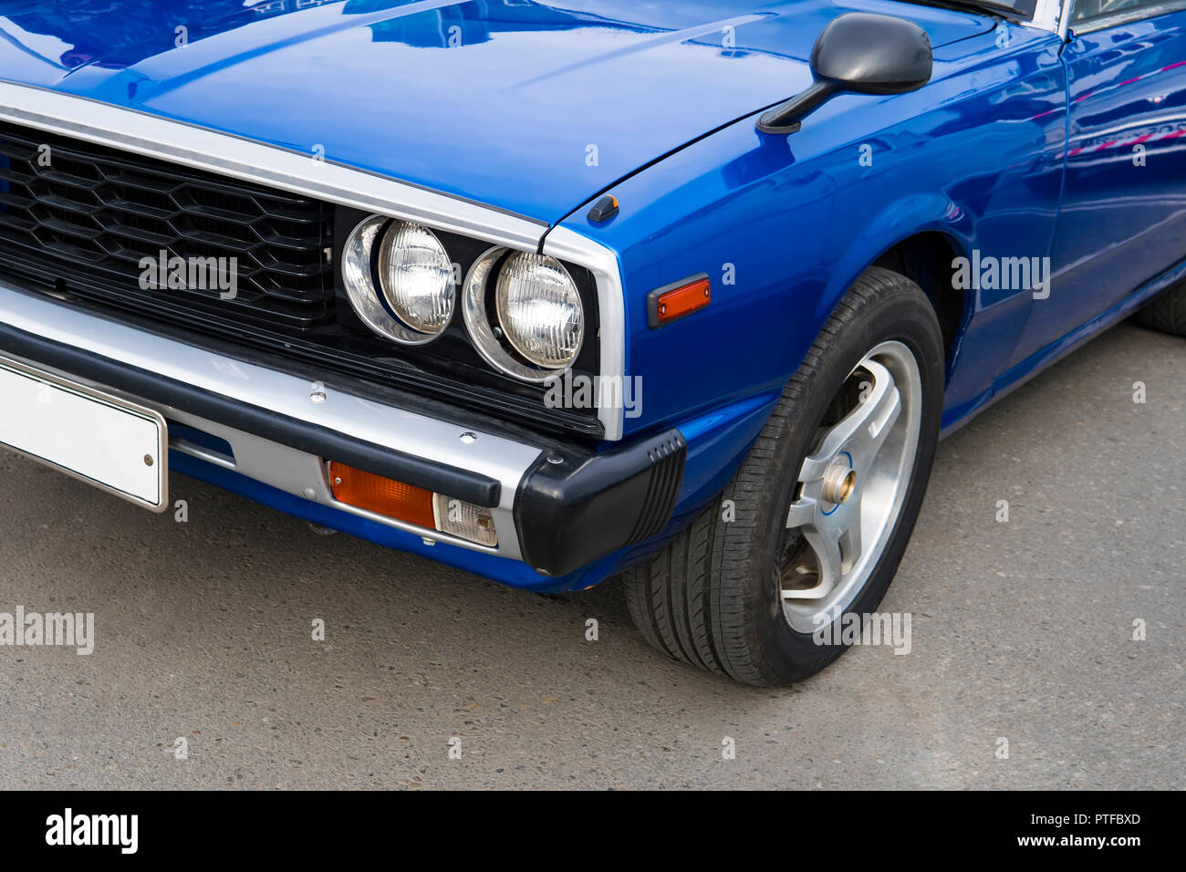 Headlight lamp of retro classic car vintage style. Polished blue shiny car on a retro exhibition 60-70 years of the 20th century. Stock Photo