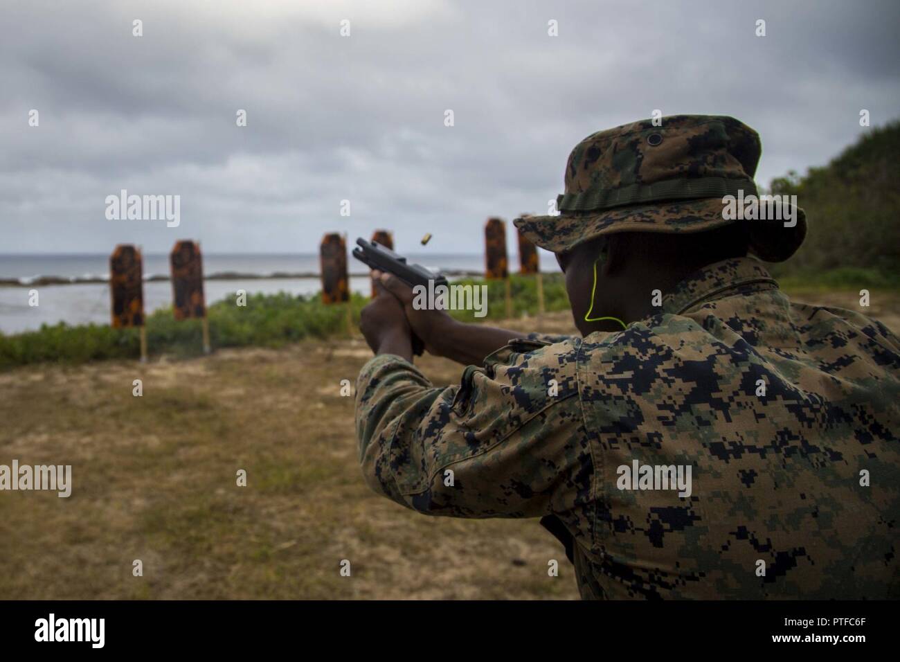U.S. Marine Corps Lance Cpl. Tyreke Wiggins, a mortarman with 3rd Battalion 4th Marines attached to Task Force Koa Moana 17, fires a glock 17 during Exercise TAFAKULA, on Tongatapu Island, Tonga, July 21, 2017. Exercise TAFAKULA is designed to strengthen the military-to-military, and community relations between Tonga’s His Majesty’s Armed Forces, French Army of New Caledonia, New Zealand Defense Force, and the United States Armed Forces. Stock Photo