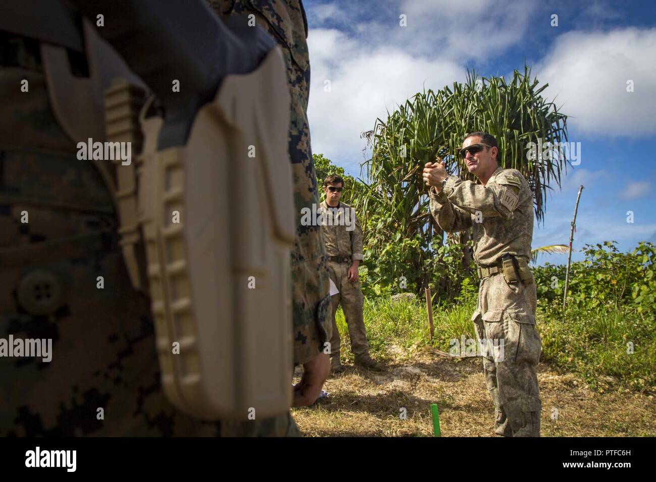 New Zealand Army Sgt. Maj. Paul Buckley, company sergeant major for delta company, shows U.S. Marines with 3rd Battalion 4th Marines attached to Task Force Koa Moana 17, how to properly hold the glock 17 during Exercise TAFAKULA, on Tongatapu Island, Tonga, July 21, 2017. Exercise TAFAKULA is designed to strengthen the military-to-military, and community relations between Tonga’s His Majesty’s Armed Forces, French Army of New Caledonia, New Zealand Defense Force, and the United States Armed Forces. Stock Photo