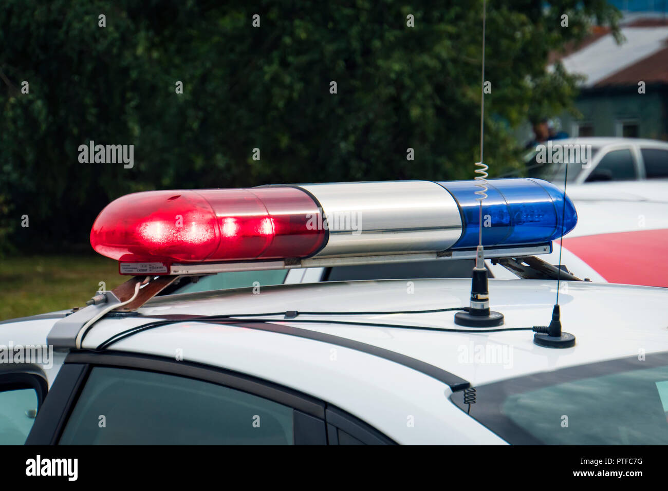 A close up of a swithched rotating beacon of a police car. Cop car rooftop flashing lights outdoors. The top of the police patrol car with flasher and Stock Photo