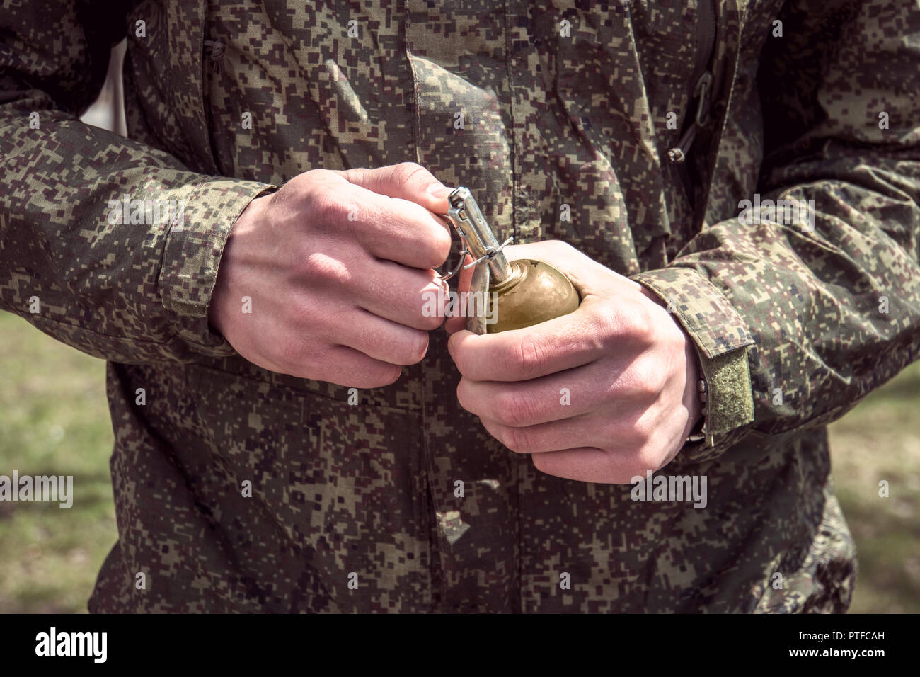Grenade, Hands on Pin. the soldier pulls a check from a fragmentation