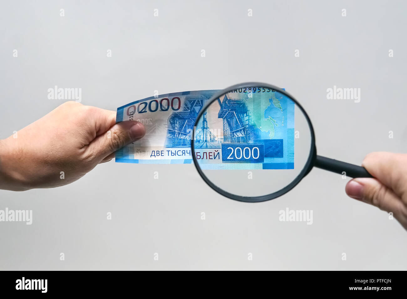 Russian currency, including new 2000 rouble bills. men's hands hold