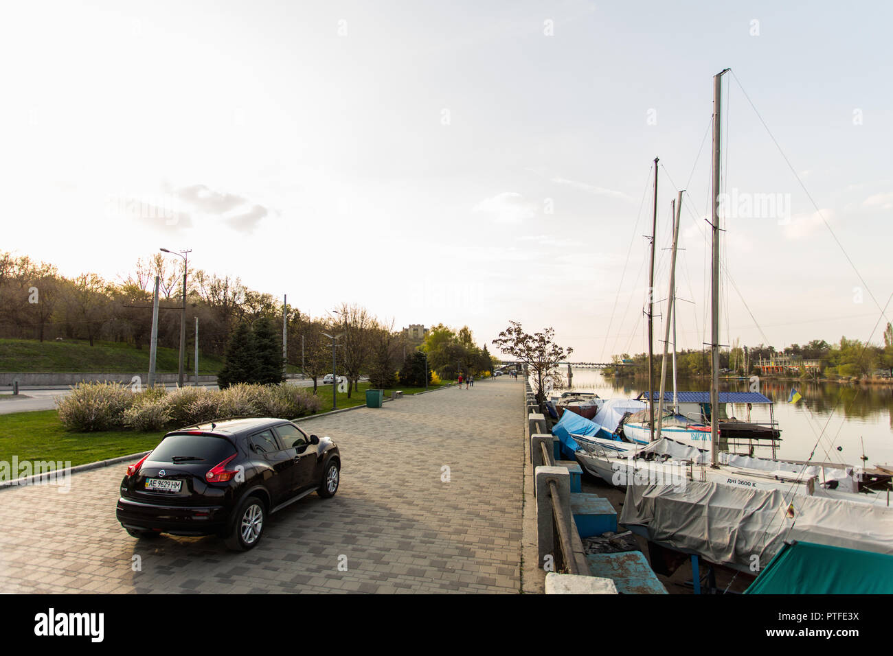 DNIPRO, UKRAINE - APRIL 12, 2016: NISSAN JUKE IN THE SPRING CITY NEAR THE BERTH AT SUNSET Stock Photo