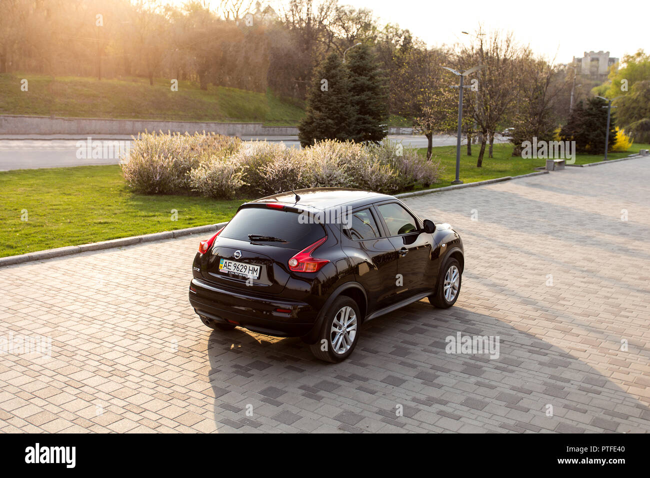 DNIPRO, UKRAINE - APRIL 12, 2016: NISSAN JUKE IN THE SPRING CITY NEAR THE PARK AT SUNSET Stock Photo