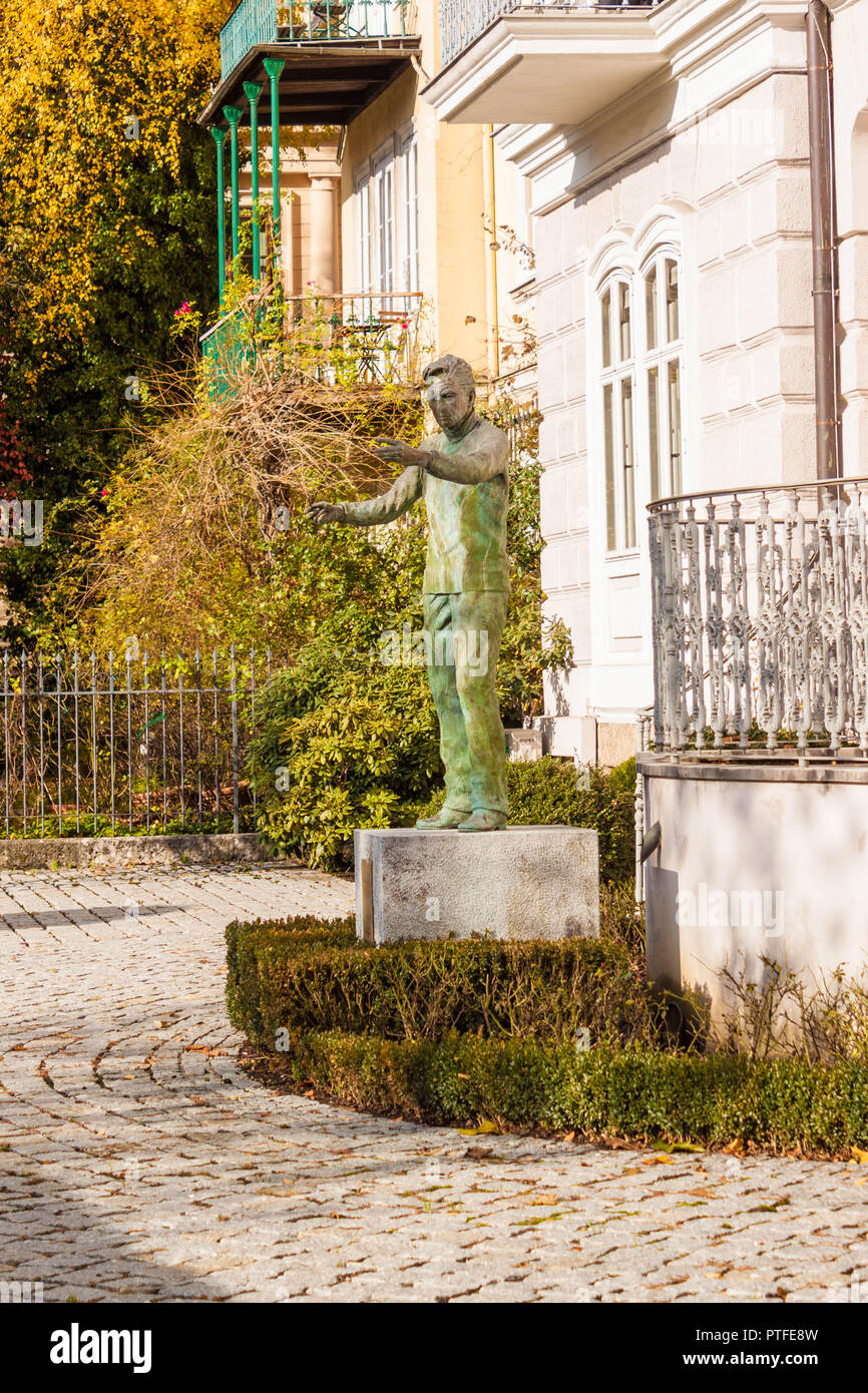 Salzburg, Austria - November 14, 2017: Life-size statue of famous conductor Herbert von Karajan in the garden of his birthplace house on Elisabethkai. Stock Photo