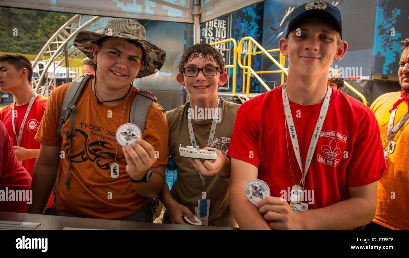 Three scouts earn the rarest of the four Navy badges given at the military exhibition site after skillfully using geo-coordinates to locate one of 94 boats hidden around the 2017 National Jamboree held on Summit Bechtel Reserve near Glen Jean, W.Va., July 21, 2017. The 2017 National Jamboree is being attended by 30,000 Scouts, troop leaders, volunteers and professional staff members, as well as more than 15,000 visitors. Approximately 1,200 military members from the Department of Defense and the U.S. Coast Guard are providing logistical support for the event. Stock Photo