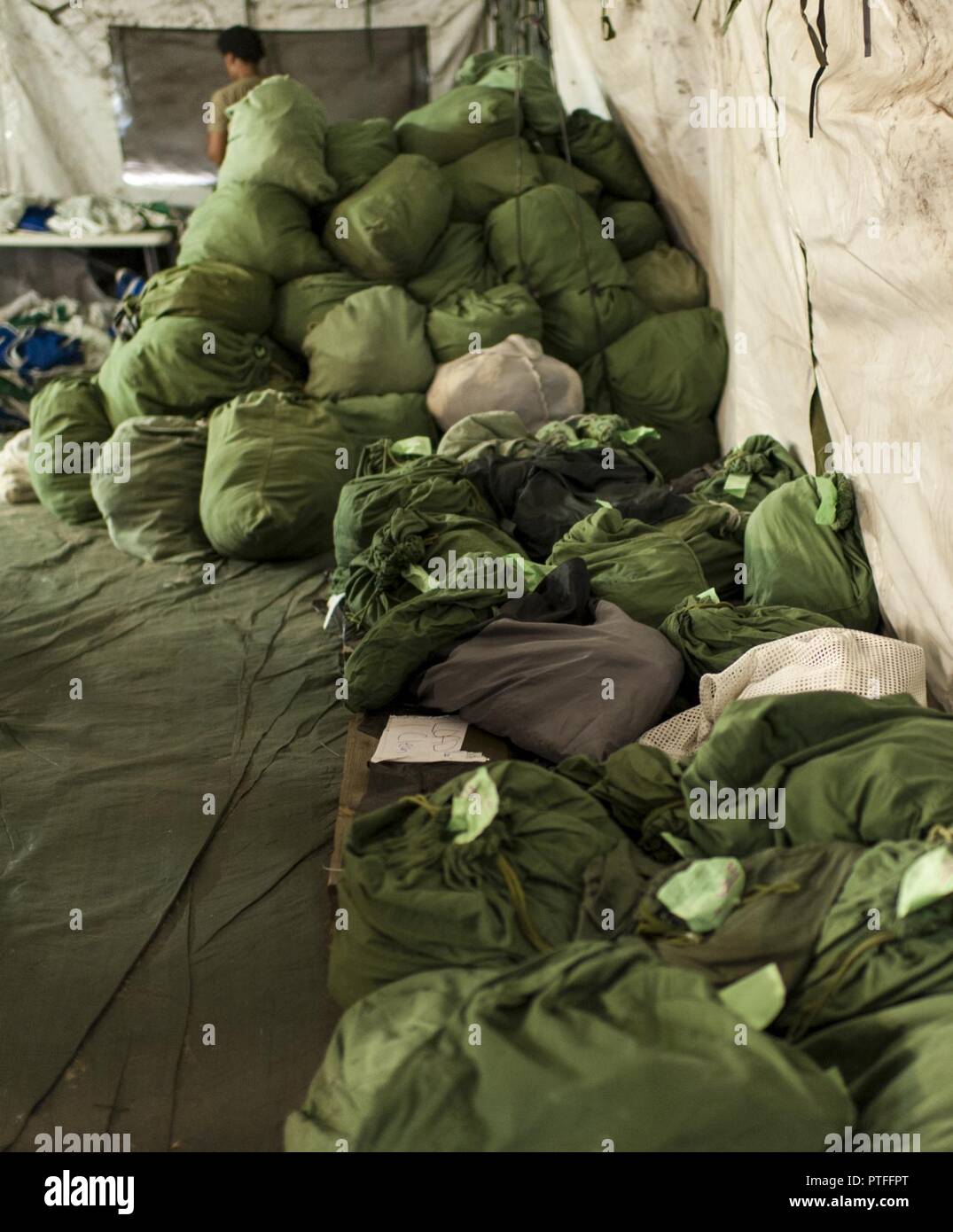 Clean laundry, in the foreground, is ready for pick up thanks to U.S. Army Reserve laundry and bath Soldiers from the 275th Quartermaster Battalion, Fort Pickett, Va.,  during QLLEX 2017, July 21, at Fort Bragg, NC. QLLEX, short for Quartermaster Liquid Logistics Exercise, is the U.S. Army Reserve’s premier readiness exercise for fuel and water distribution. This year’s QLLEX is not only a full demonstration of the capability, combat-readiness, and lethality of America’s Army Reserve to put fuel and water where it is needed most – in the vehicles and hands of the war-fighter and maneuver units Stock Photo