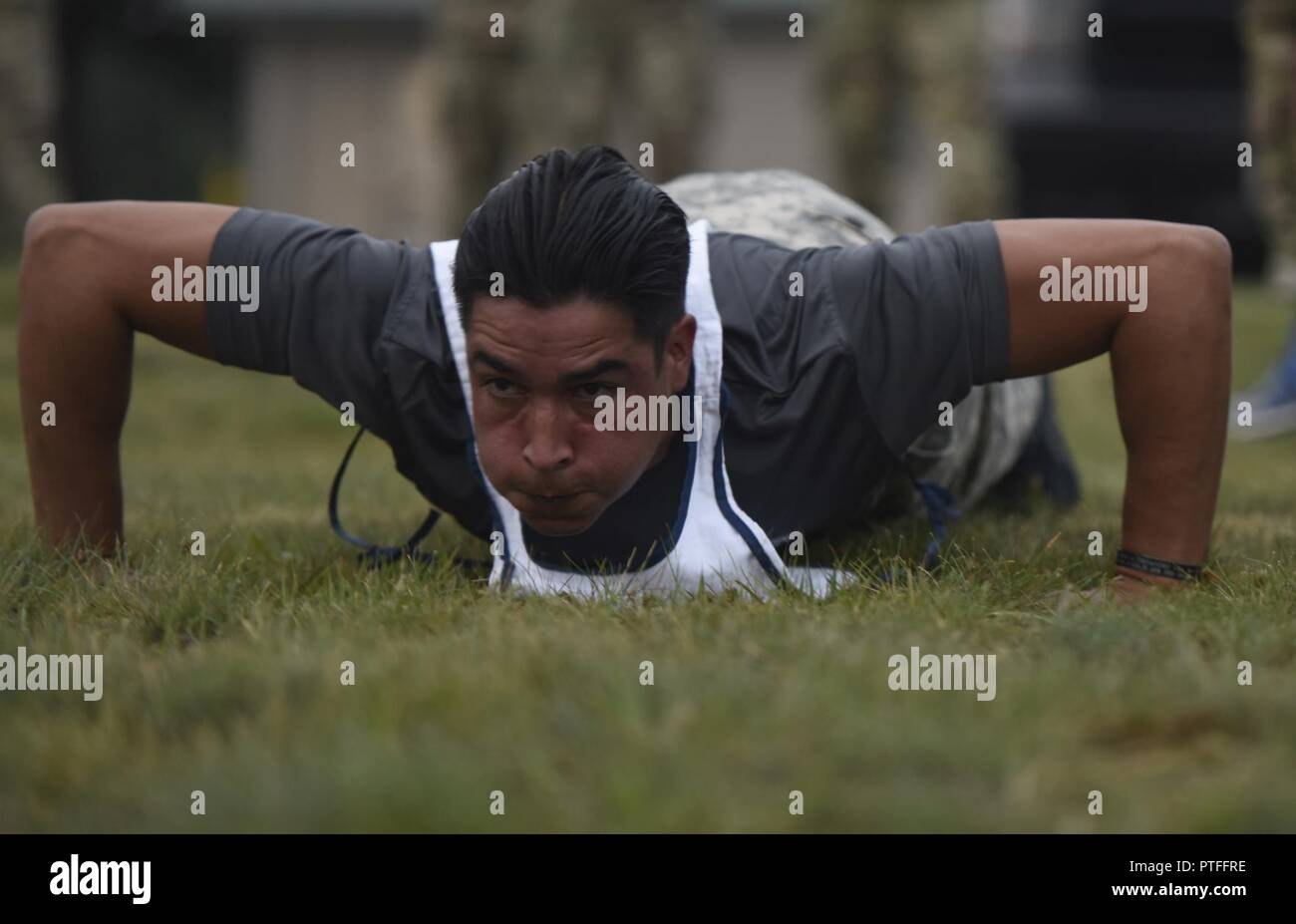 Sgt. Michael Cohen with the D.C. National Guard completes the push-up event of the Army Physical Fitness Test for the 2017 Army National Guard Best Warrior Competition at Camp Ripley, Minnesota, July 18, 2017. The event, originally scheduled for the night prior, was delayed by severe weather and be would be the first of many physically-demanding challenges the competitors would undergo on Day 2. Minnesota National Guard Stock Photo