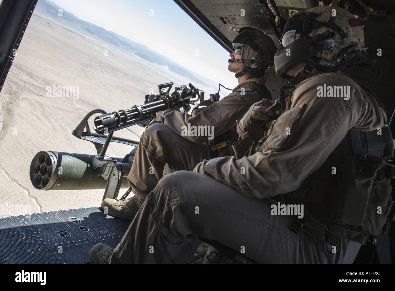 U.S. Marine Corps Staff Sgt. Dustin S. Miller, (left), Crew Chief, and