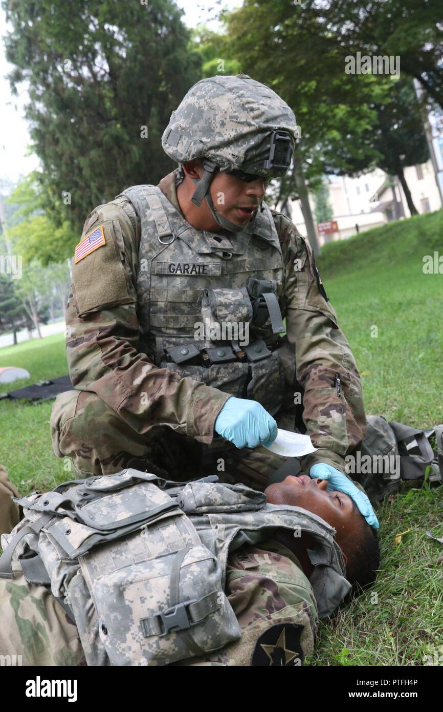 Spc. Jorge H. Garatecarabajo, a wheeled-vehicle mechanic assigned to 579th Forward Support Company, 6th Battalion, 37th Field Artillery Regiment, 210th Field Artillery Brigade, 2nd Infantry Division/ROK-US Combined Division, simulates applying a nasopharyngeal tube to a simulated patient at Camp Casey, South Korea, July 21, 2017. Soldiers put their knowledge to the test during the final exercise after a week-long training on CLS by acting out real-world scenario of finding a casualty while on patrol and applying medical aide. Stock Photo