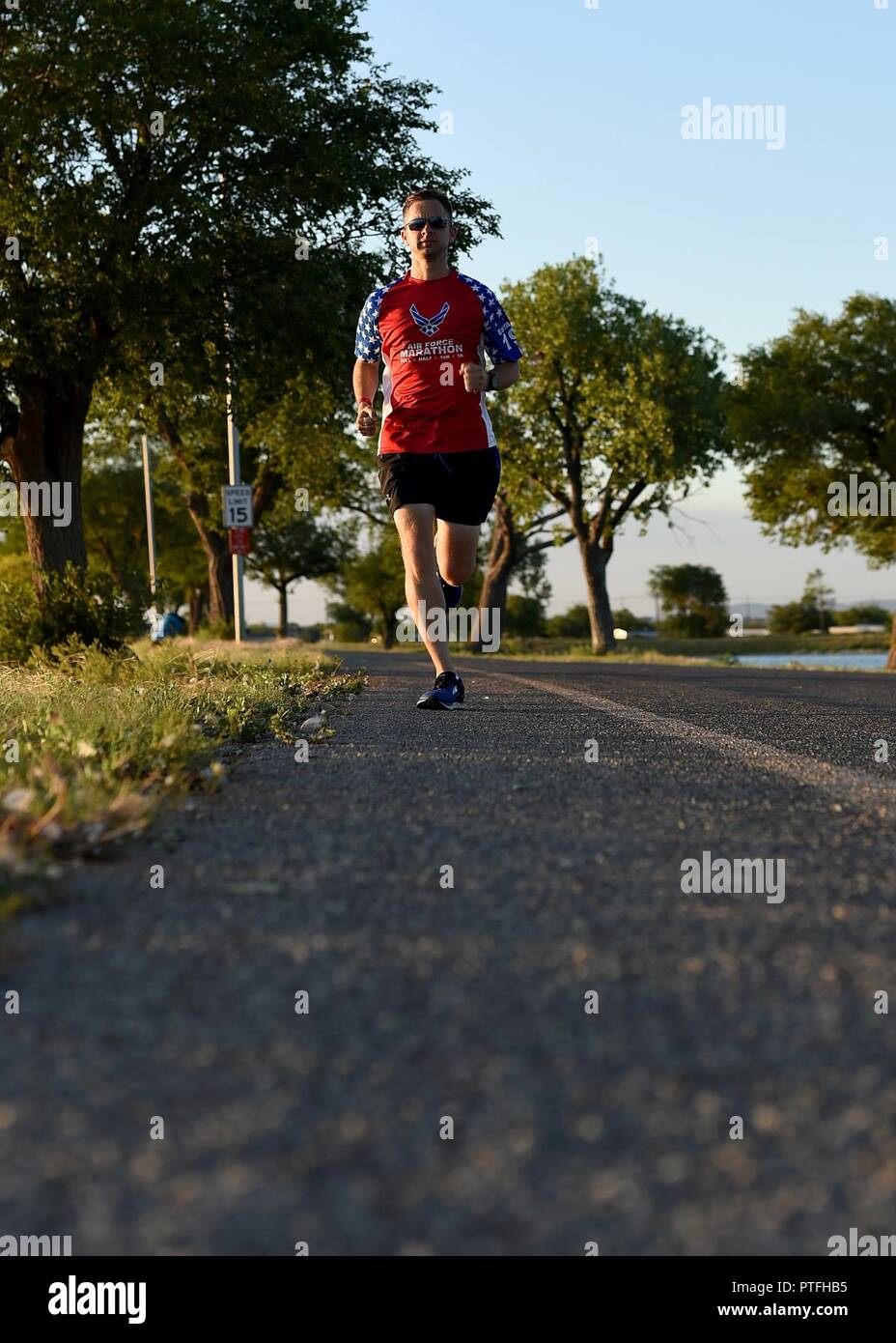 U.S. Air Force Tech. Sgt. Logan Berry, 54th Air Refueling Squadron instructor boom operator, paces himself while running, July 20, 2017 at Altus, Oklahoma. After an unsuccessful running portion of a physical training test, Berry motivated himself to become a better runner and has competed in several long-distance running events, including the Air Force Marathon. Stock Photo