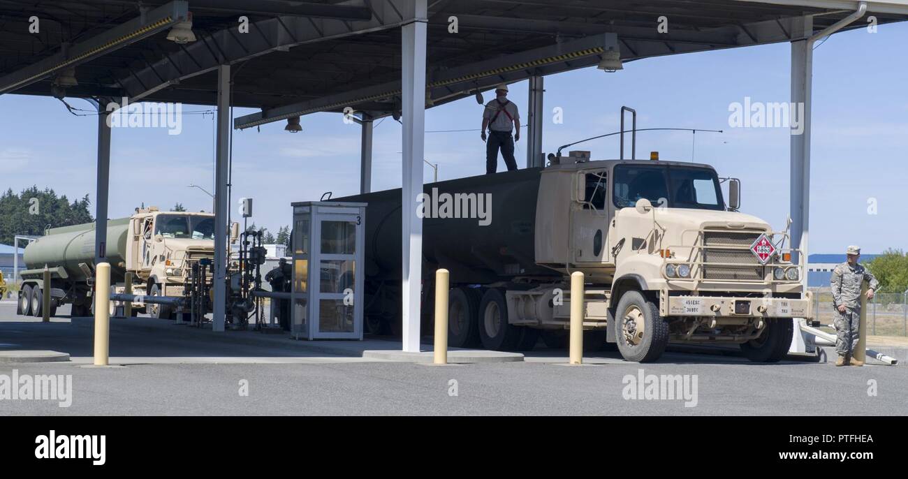 OAK HARBOR, Wash. (July 20, 2017) United States Army 475th Quartermaster Group fuel trucks arrive at Naval Air Station Whidbey Island to offload fuel during the 2017 Quartermaster Liquid Logistics Exercise (QLLEX). QLLEX is an annual exercise for Army Reserve units to train for their wartime mission of providing petroleum and water to units throughout the continental United States. This year’s exercise had convoys of Army trucks based out of Joint Base Lewis-McCord (JBLM) transporting fuel provided by Naval Supply Systems Command Fleet Logistics Center Puget Sound’s Manchester Fuel Depot to mi Stock Photo