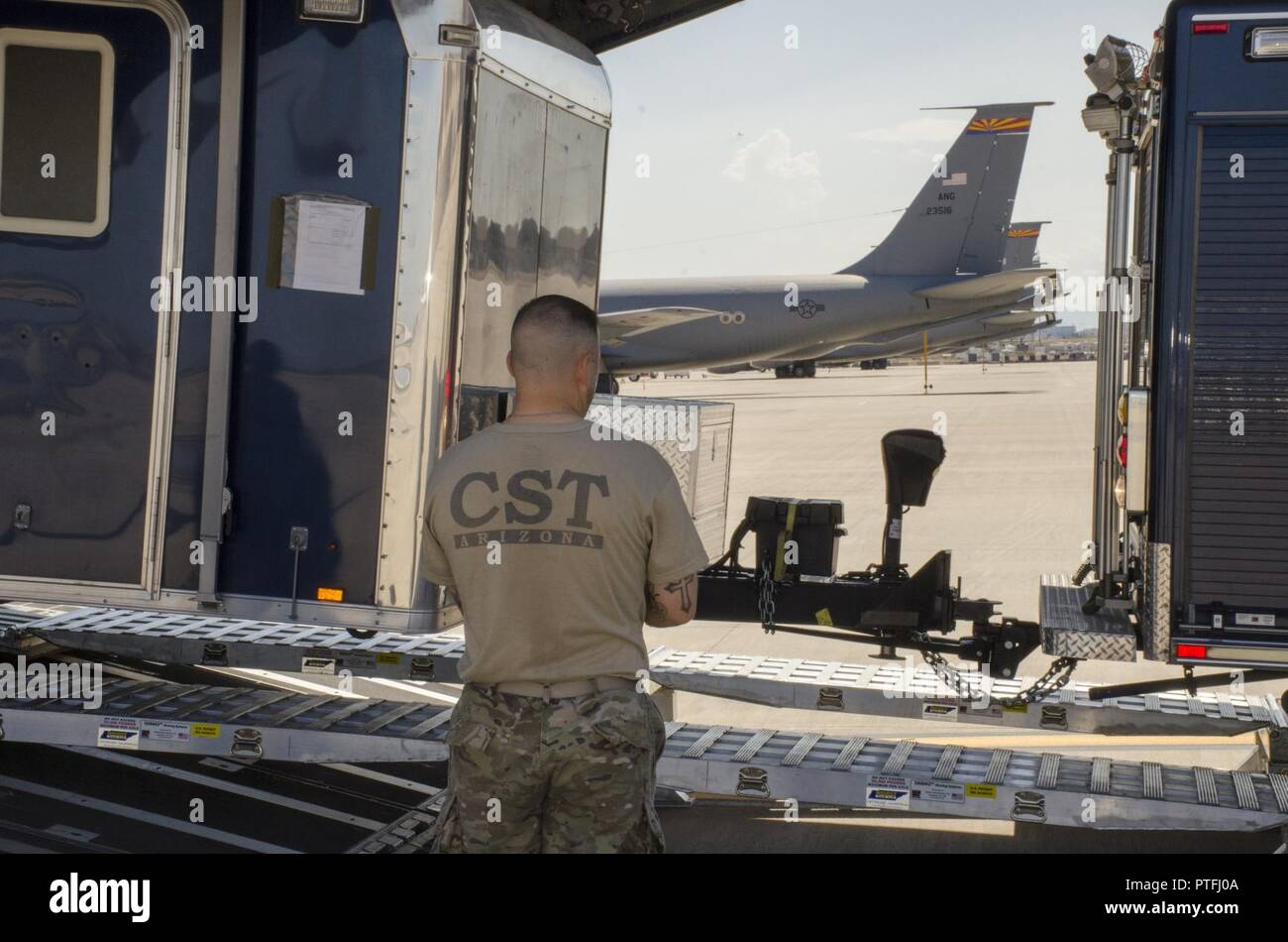 Army 1st Lt. James Freda, the Survey Team Leader with the Arizona National Guard’s 91st Civil Support Team, helps guide a vehicle and trailer onto a C-17 Globemaster cargo aircraft at Goldwater Air National Guard Base July 18. The 91st traveled to Buckley Air Force Base to participate in a multi-CST exercise to train together in one location for a large or widespread incident. (Ariz. Army National Guard Stock Photo