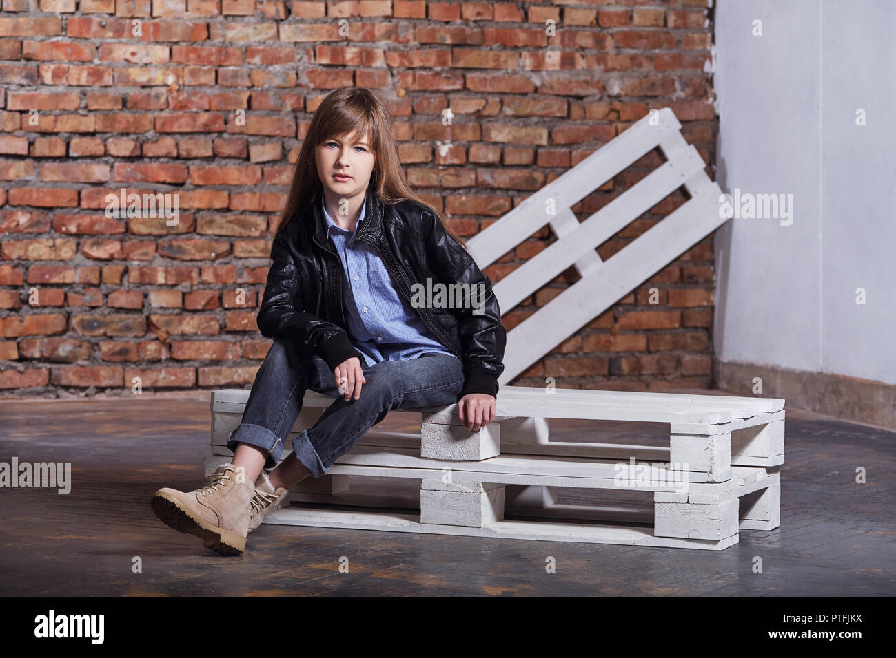fashion teen girl. girl loft interior. posing brick wall. Stylish girl hipster teen. Stock Photo