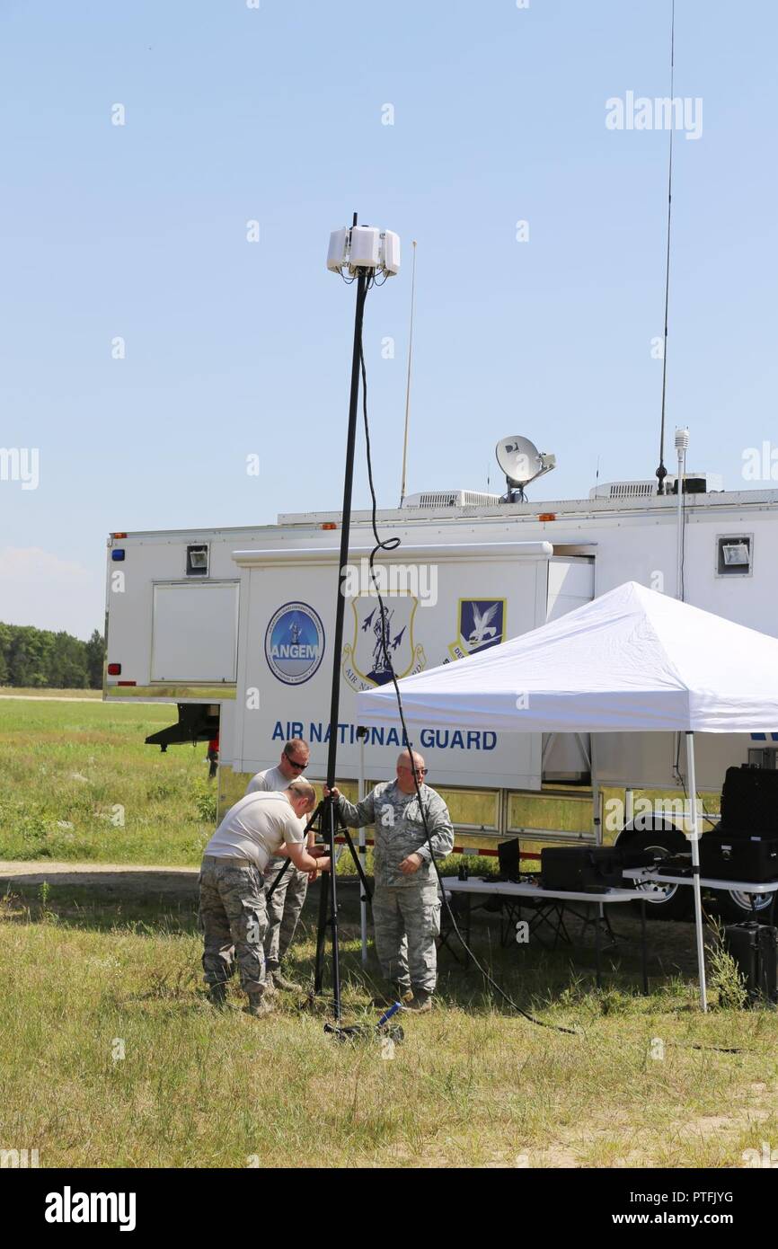 Airmen with the Oregon Air National Guard’s 270th Air Traffic Control Squadron at Kingsley Field Air National Guard Base in Klamath Falls set up for operations July 18, 2017, for air traffic control during the Patriot North 2017 Exercise at the Young Air Assault Trip at Fort McCoy, Wis. Patriot North is a training exercise designed for civilian emergency management and responders to work with military entities in the same manner that they would during disasters. The exercise tests the National Guard’s abilities to support response operations based on simulated emergency scenarios, such as a st Stock Photo
