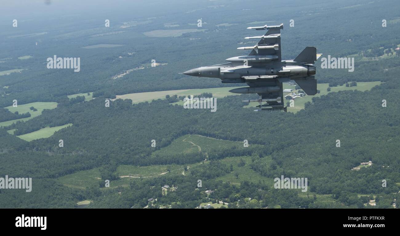 A Four-Ship formation of F-16 Fighting Falcons fly over Shaw Air Force Base, S.C., 21 July, 2017, as part of a commemoration of the hundredth anniversary of the 55th Fighter Squadrons activation. The formation consisted of the wing flagship aircraft from the 55th, 77th, and 79th fighter squadrons all stationed at Shaw AFB. Stock Photo