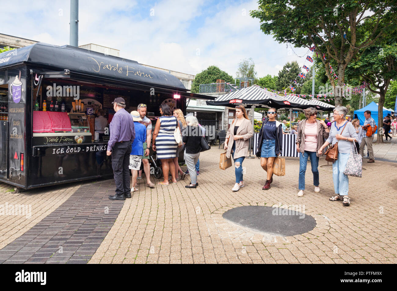 2 June 2018: Plymouth, Devon, UK - Customers gathered around a food stall selling cold drinks and ice cream at Flavour Fest, Plymouth, Devon, UK Stock Photo