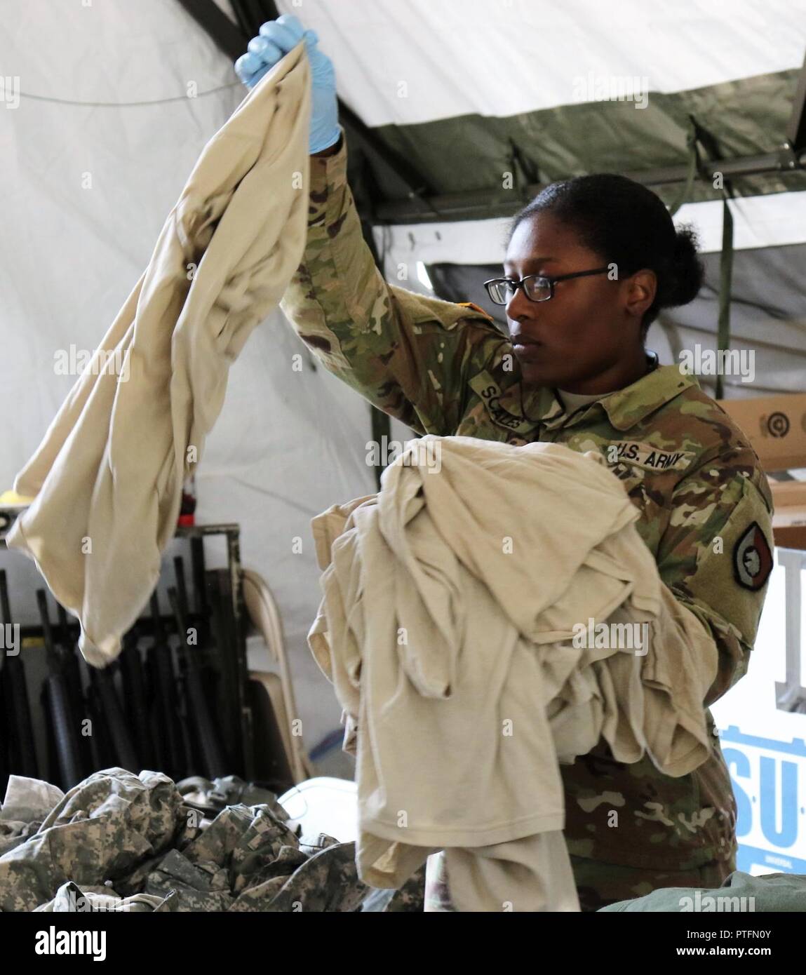 U.S. Army Reserve Pvt. 1st Class Sondra Scales, a utilities equipment repairer with the 340th Quartermaster Company, sorts laundry during the two-week 2017 Quartermaster Liquid Logistics Exercise at Joint Base Lewis McChord, WA, Jul. 14 to 27, 2017.  QLLEX allows U.S. Army Reserve units to demonstrate their skills and provide real-world fuel and water support while training at the tactical, operational, and strategic level. Stock Photo