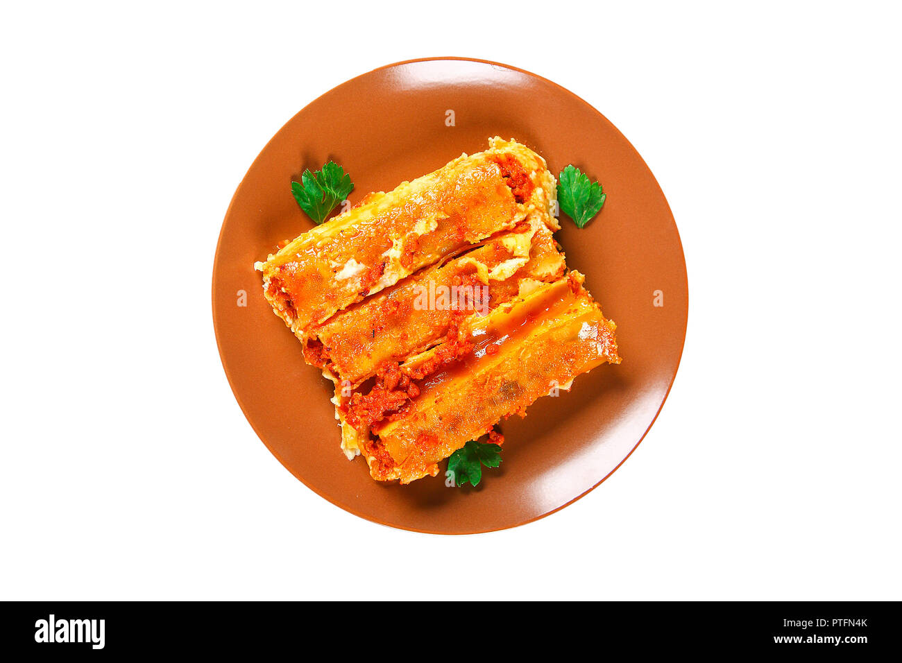 Traditional Italian pasta cannelloni. Baked tubes stuffed with minced meat with parmesan cheese and bechamel sauce on a white background. Cannelloni p Stock Photo