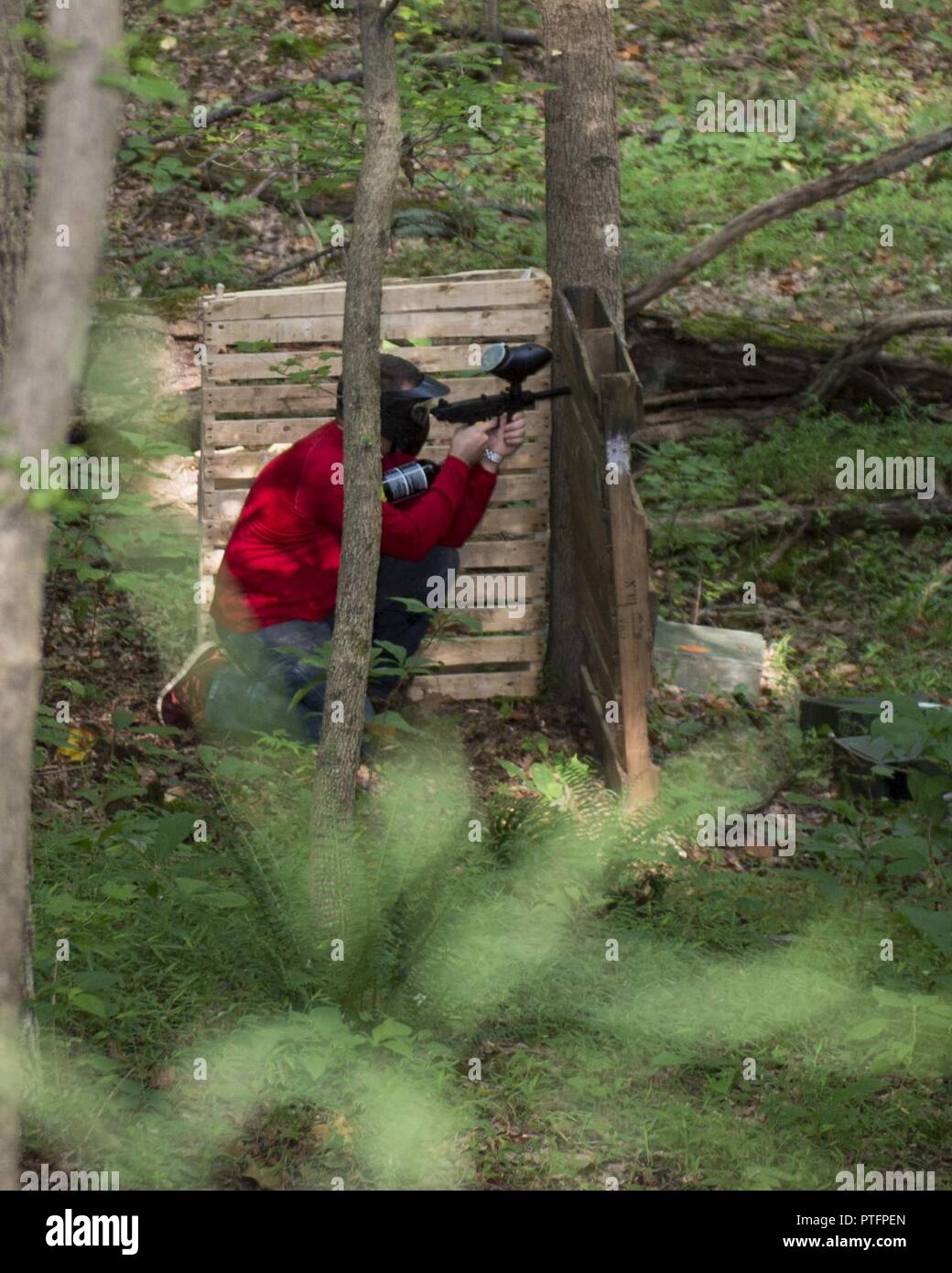 An attendee takes cover during the Quantico Paintball Park grand