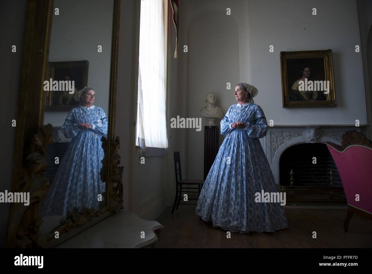 Docent volunteer, Roberta 'Bobbie' Jones, stands in the White Parlor room of the Arlington House, a Robert E. Lee Memorial, in Arlington National Cemetery, Arlington, Va., July 19, 2017.  In July of 2015, philanthropist David M. Rubinstein announced a $12.35 million donation to the National Park Foundation’s Centennial Campaign for America’s National Parks to restore and improve access to Arlington House.  This work is scheduled to begin in late August 2017, limiting access to visitors. Stock Photo