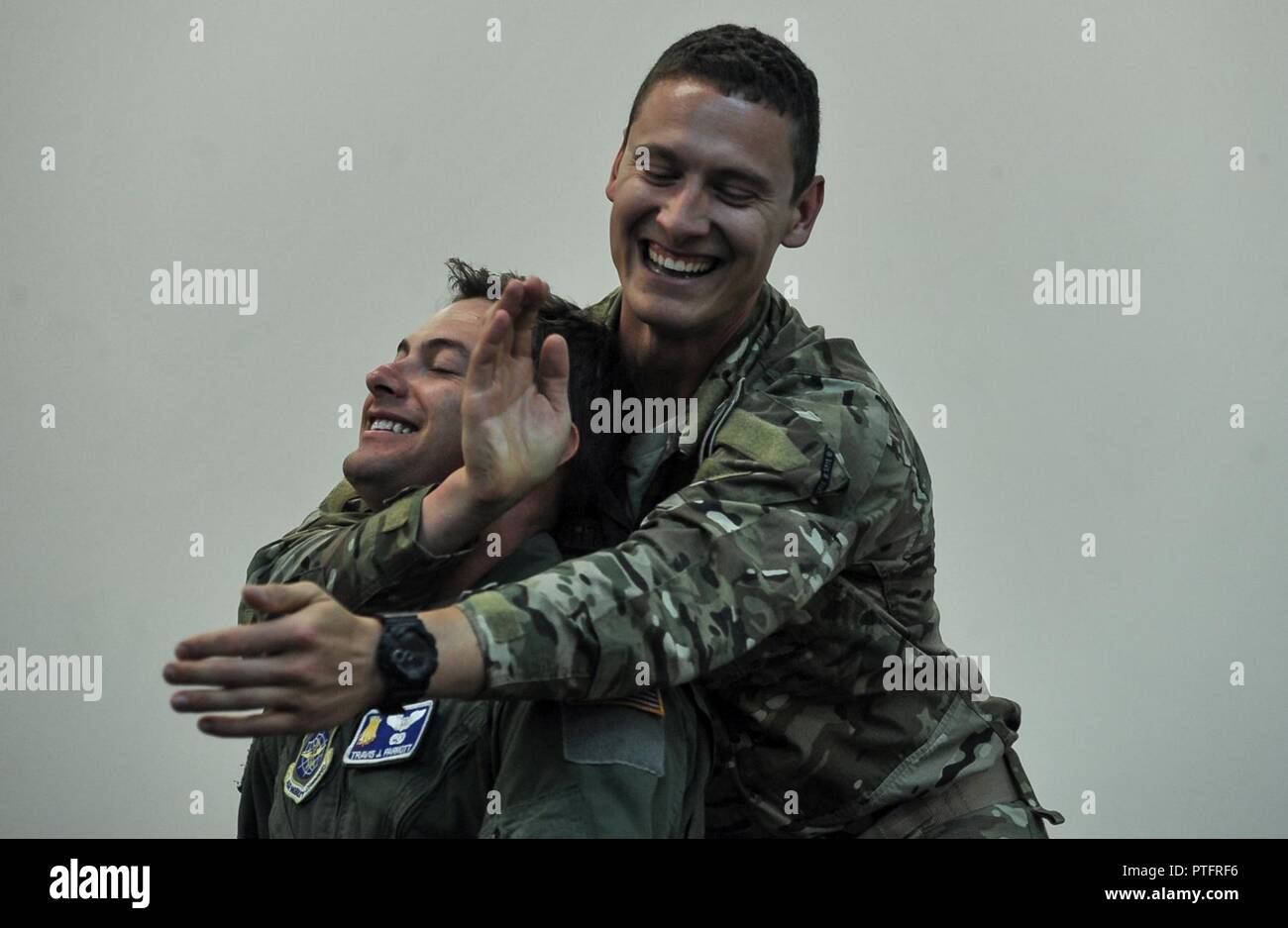 U.S. Army Sgt. 1st Class Joe Baker demonstrates a choke hold on Officer  Candidate Wendy McDougall during combatives training at the Bethany Beach  Training Site in Bethany Beach, Del., June 7, 2015.
