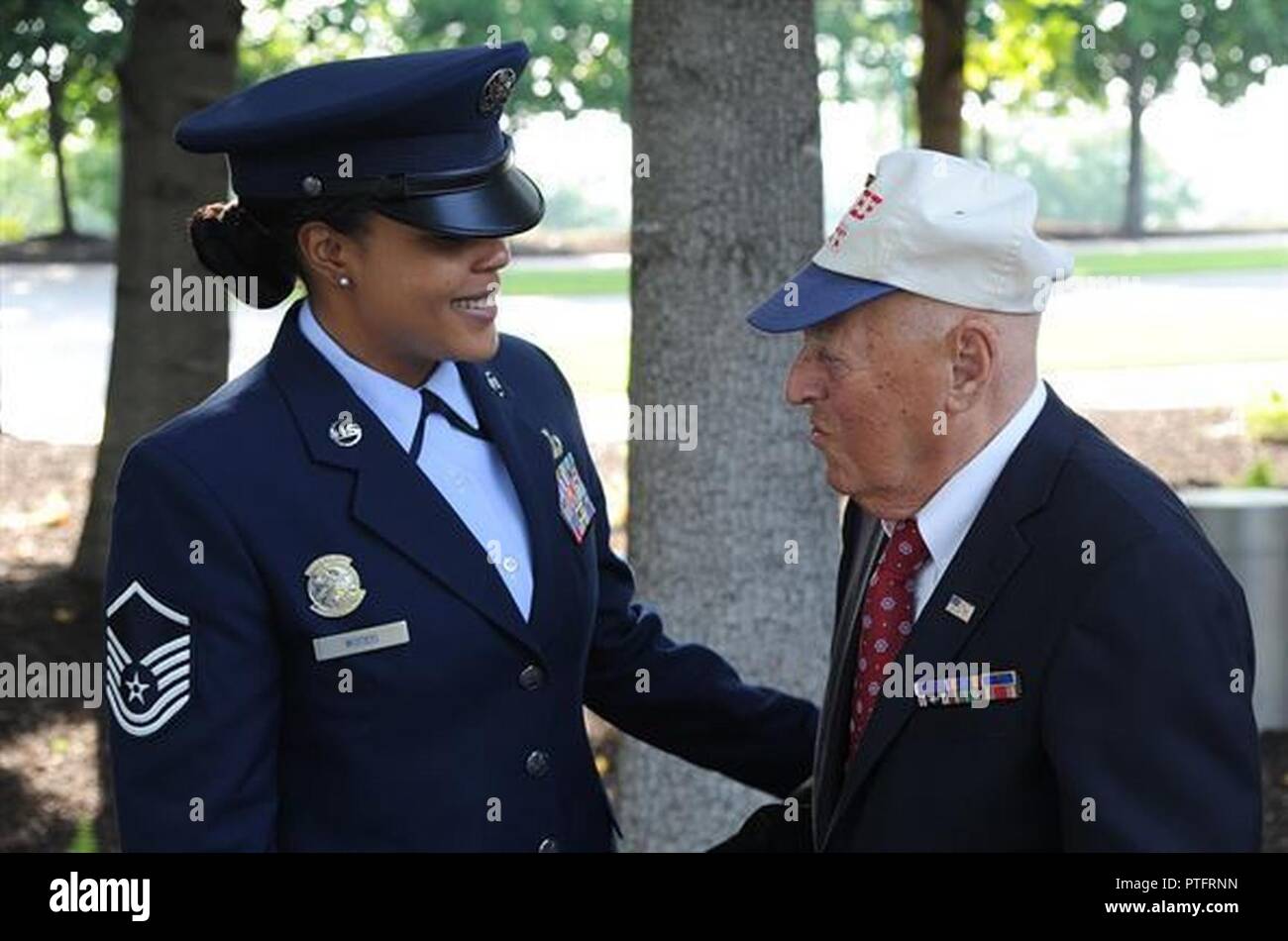 Master Sgt. Tamekia Wood, U.S.Air Force Honor Guard, assists 2nd Lt. (Ret.) John Pedevillano before his Purple Heart award ceremony on July 14, 2017 at the U.S. Air Force Memorial, Arlington, Va. Maj. Gen. James A. Jacobson, Air Force District of Washington commander, hosted the Purple Heart award ceremony and presented the prestigious award to 2nd Lt. (Ret.) John Pedevillano for wounds he incurred during a forced march as a World War II prisoner of war in Germany. Pedevillano, a B-17 bombardier pilot, and his crew assigned to the 306th Bomb Group of the “Mighty Eighth” Air Force were shot dow Stock Photo