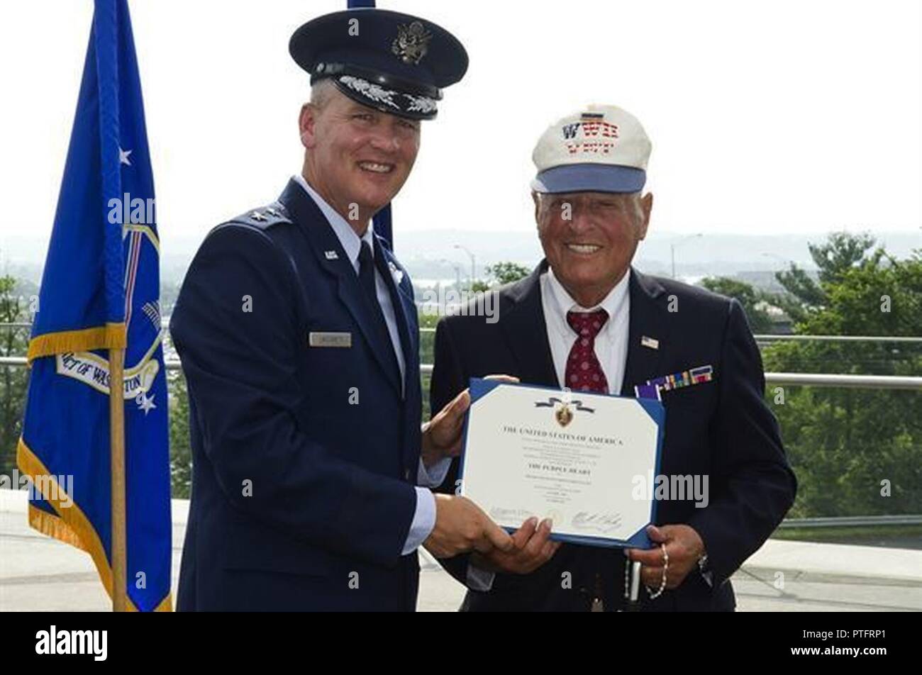 Maj. Gen. James Jacobson (left) presents a Purple Heart certificate to Lt. John Pedevillano, July 14, 2017. Stock Photo