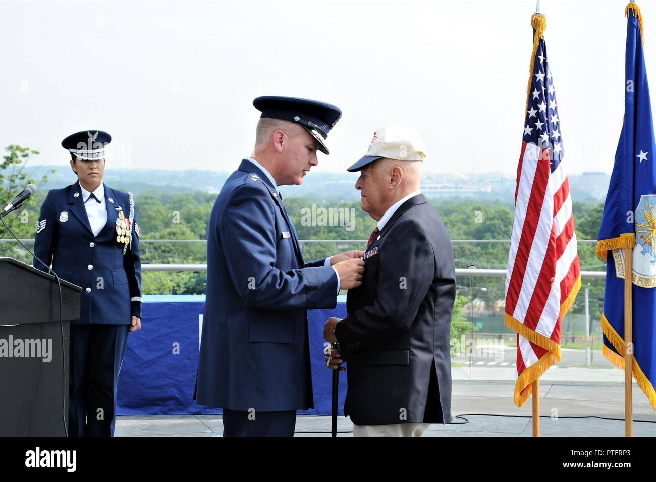 Maj. Gen. James A. Jacobson (second from right), Air Force District of Washington commander, pins a Purple Heart ribbon on World War II veteran, Lt. John Pedevillano, during an award presentation ceremony July 14, 2017 at the U.S. Air Force Memorial, Arlington, Va. Pedevillano, a B-17 bombardier pilot, and his crew assigned to the 306th Bomb Group of the “Mighty Eighth” Air Force were shot down during a bombing mission in airspace over Nazi Germany on April 24, 1944. (Air Force Stock Photo