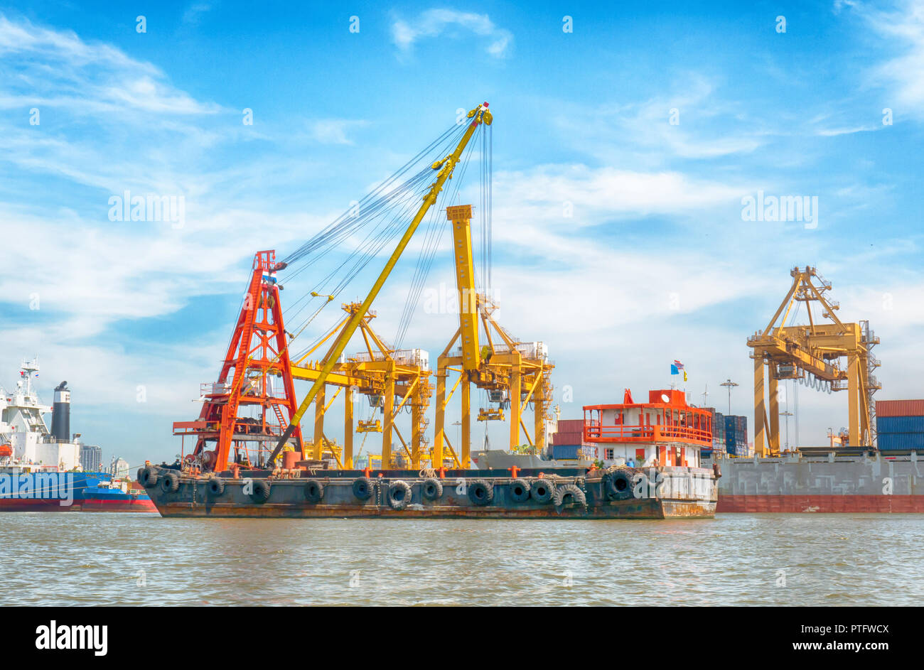 Logistics and transportation of container cargo ship with working crane bridge in shipyard at sunrise, logistic import export concept and transport in Stock Photo