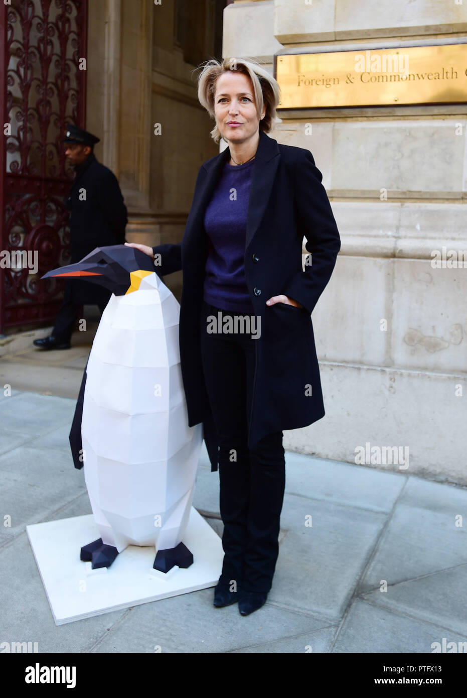 Gillian Anderson with a sculpture of a penguin outside the Foreign & Commonwealth Office in London before delivering a 350,000-strong petition calling on the government to protect the Antarctic. Stock Photo