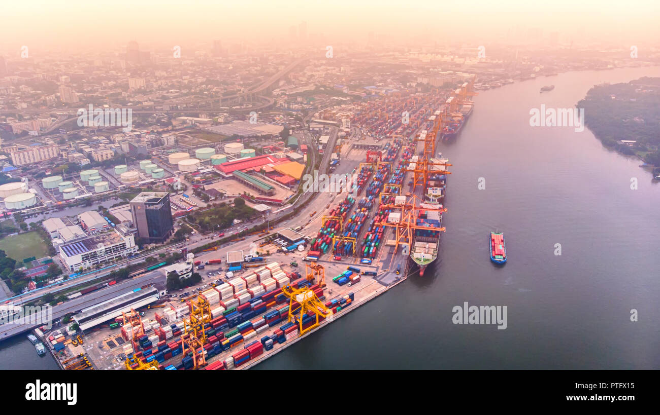 Weather with the haze of global change, and logistics and shipping of container ships and import / export goods, and logistics business, shot from dro Stock Photo