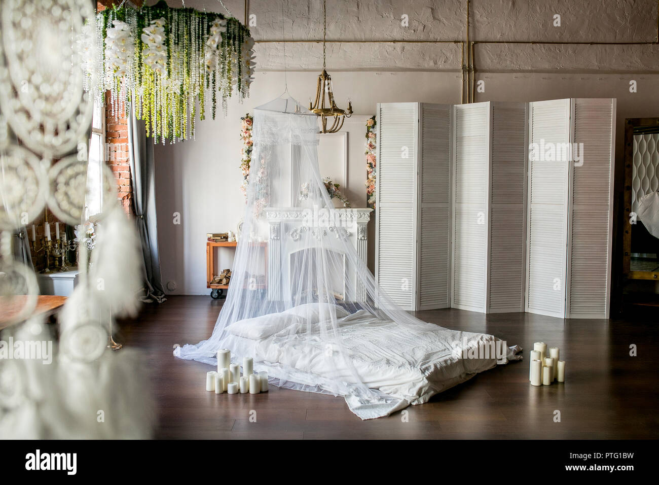Loft Style Room With A Bed A Canopy A White Fireplace With