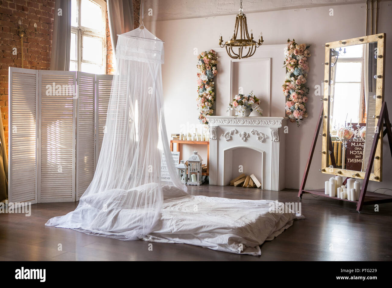 Loft Style Room With A Bed A Canopy A White Fireplace With