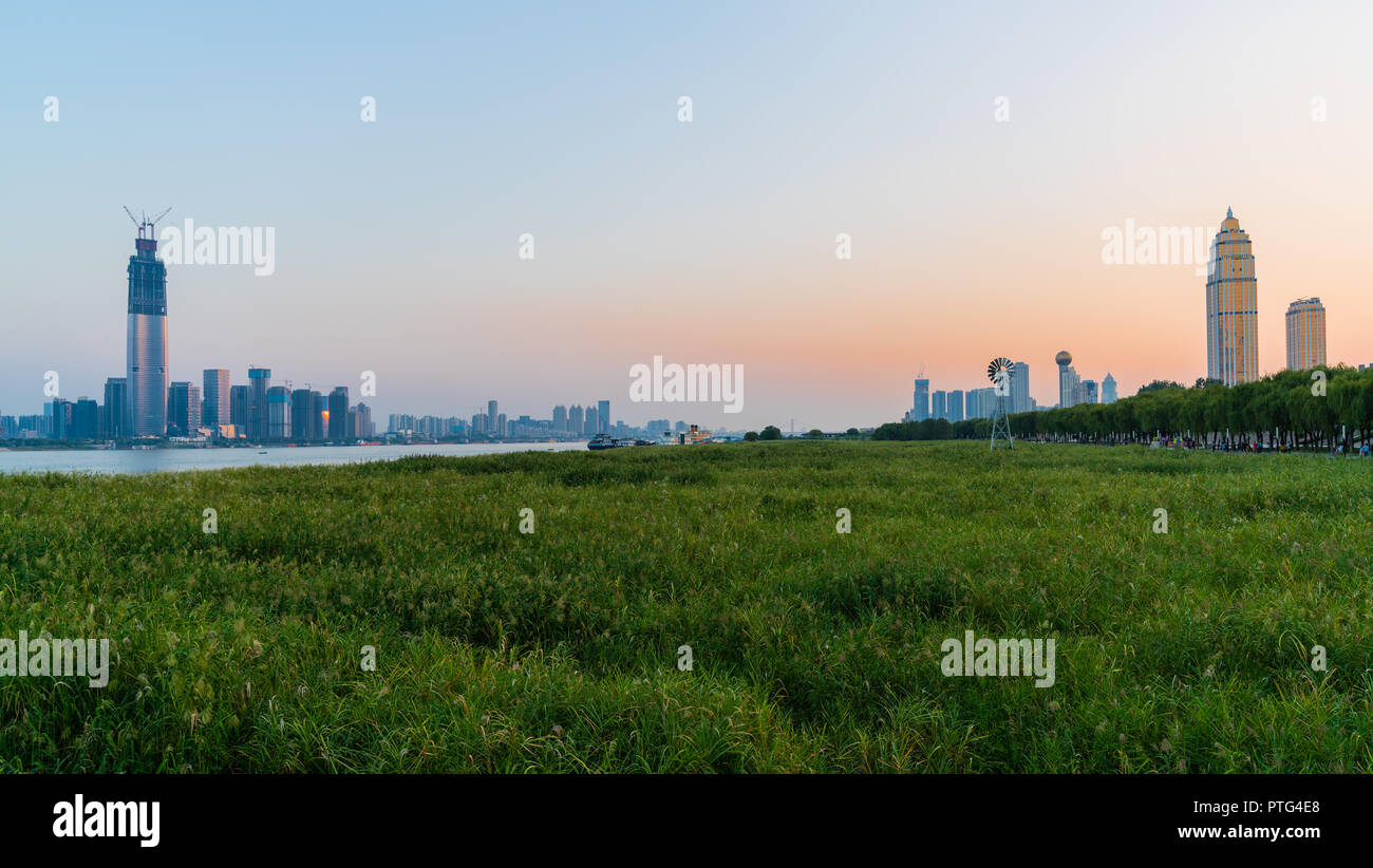 Panorama of Wuhan cityscape at sunset with Wuchang and Hankou districst skyline and both side of Yangtze riverbank in Wuhan Hubei China Stock Photo