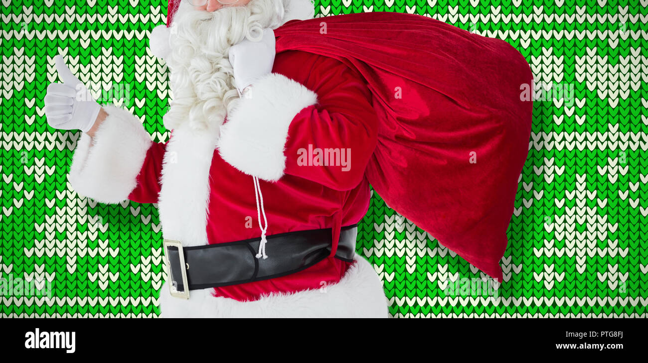 Composite image of positive santa with his sack and thumbs up Stock ...