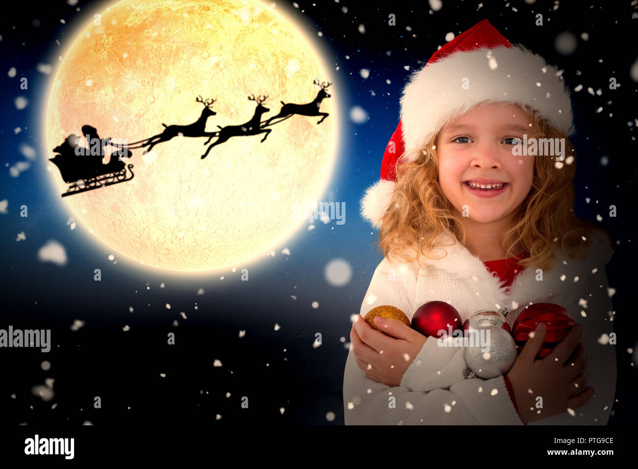 Composite image of festive little girl smiling at camera Stock Photo ...