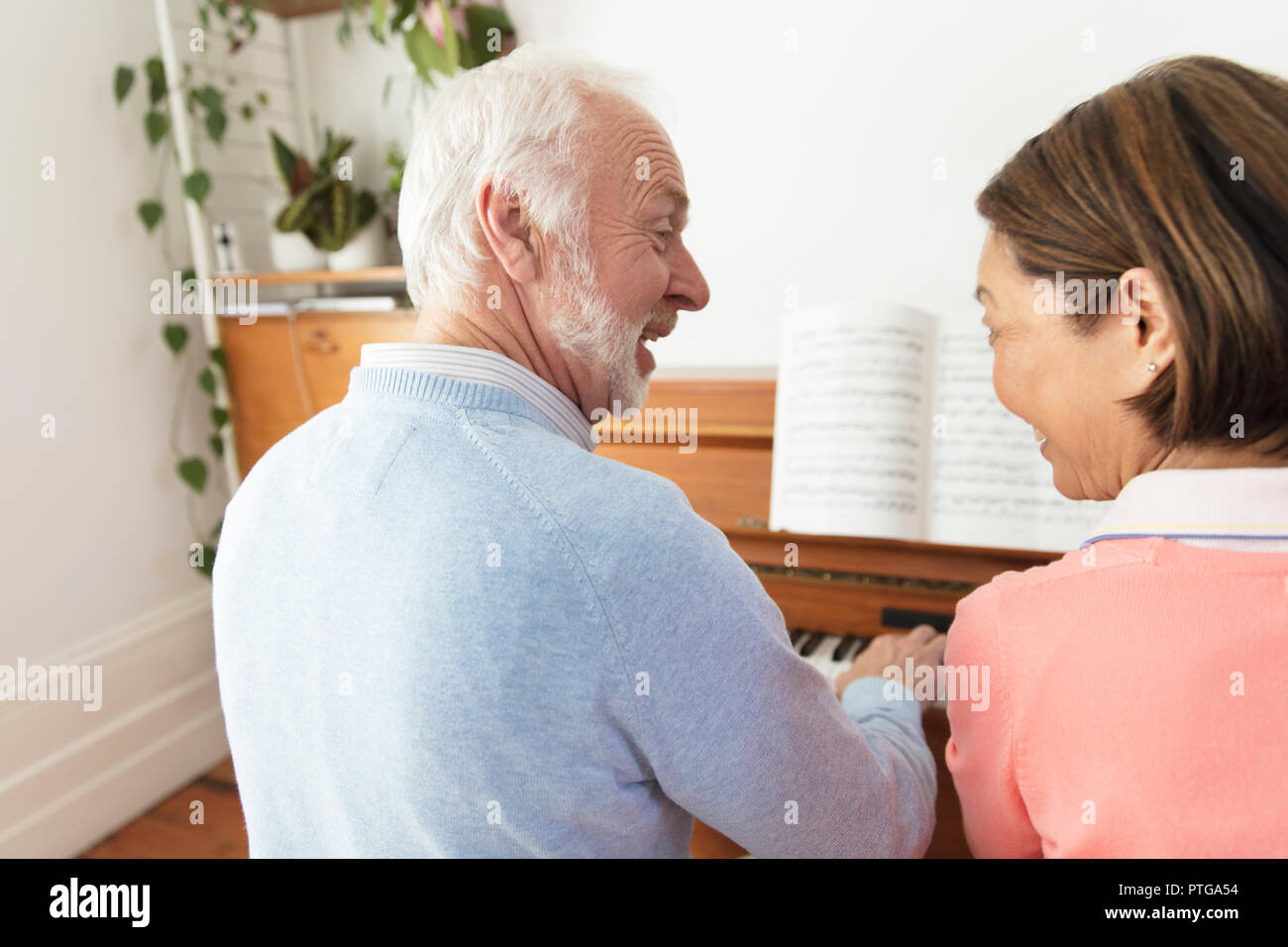 Active senior couple playing piano Stock Photo